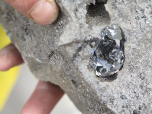 Jordan displays how the Herkimer diamonds are found embedded in the rock, at the Herkimer Diamond Mines © 2015 Karen Rubin/news-photos-features.com