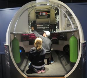 Dive, dive, dive: pretending to pilot ALVIN at the WHOI exhibit center in Woods Hole © 2016 Karen Rubin/news-photos-features.com