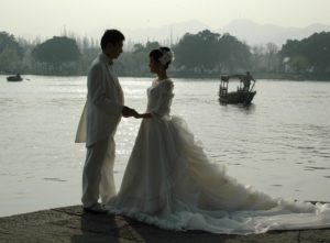 Hangzhou is the “City of Love”: a bridal couple poses for pictures beside West Lake © 2016 Karen Rubin/goingplacesfarandnear.com